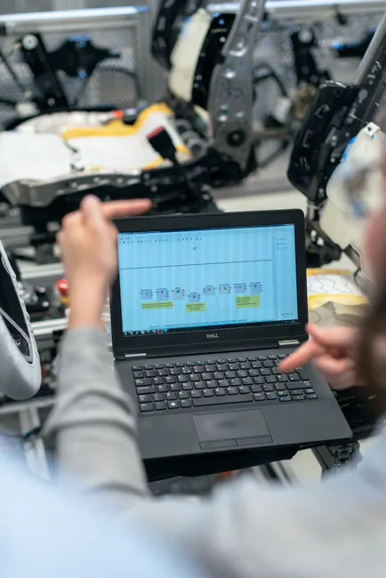 Engineers using a laptop to analyze software data